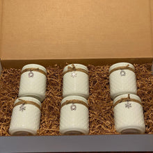  6 white glass jar hobnail candles in a cardboard box