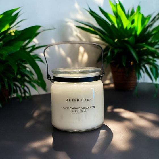 20oz KANA Candle with double wick in a glass jar with black handle lovely after dark scent and option to personalize label