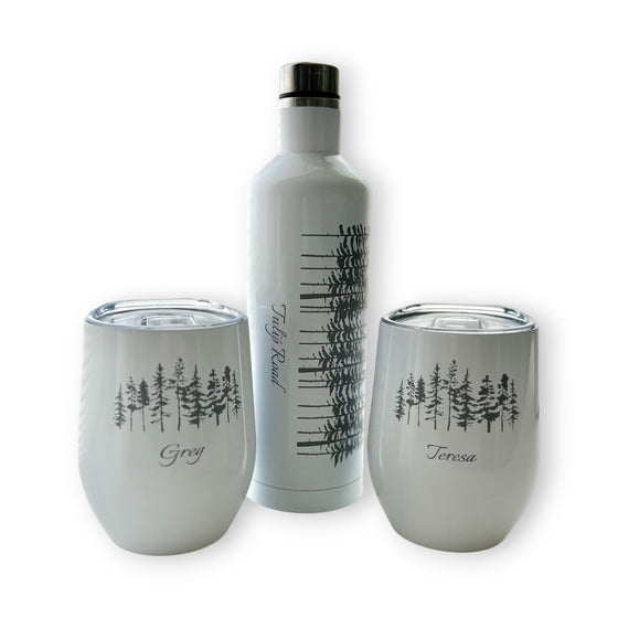 Set of white insulated tumblers with tree design and names on a white background