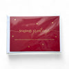 Red greeting card with gold embossed 'seasons greetings' text and stars on a white background