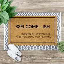  Coir door mat with funny saying on top of a woven rug with sneakers and a plant on the side