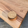 Backide of Cherry Live Edge Charcuterie Board showing close up of corked feet