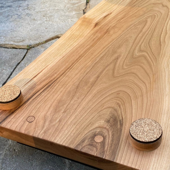 backside of chery board showing round corked feet and grain of wood