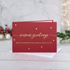Red Christmas Card with Christmas Wishes in gold leaf cursive font with gold stars